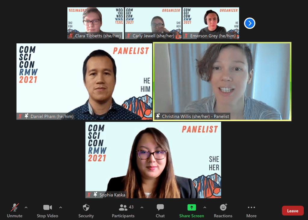 Christina talks at a virtual event with a gray shirt on, against the backdrop of a white wall and gray curtains. Other event panelists and 
organizers are present on the screen.